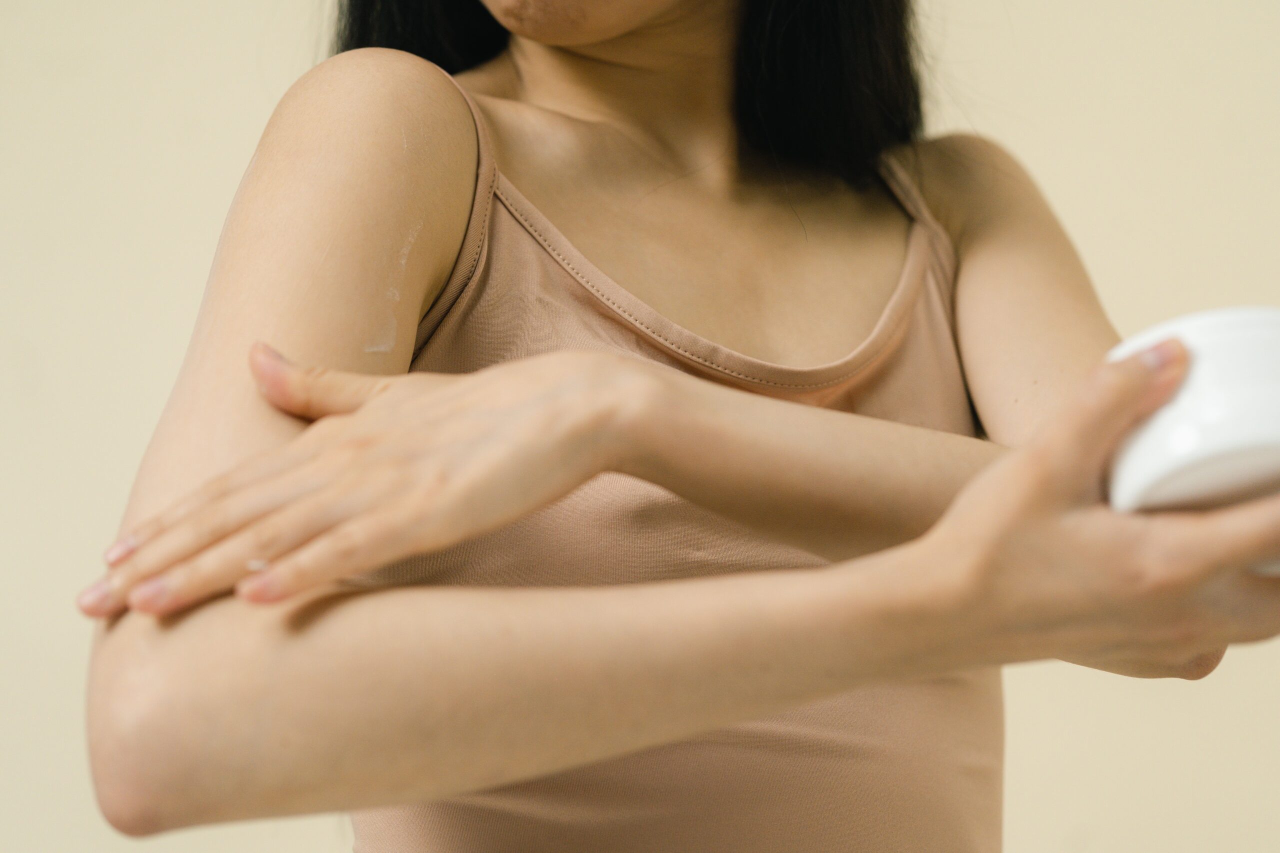 Applying lotion to hydrate dry skin